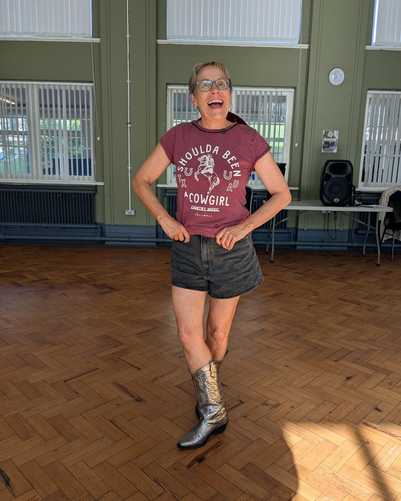 Laura smiling in cowboy boots at a line dancing venue